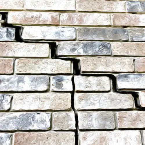 Large cracks on a retaining wall caused by hydrostatic pressure.