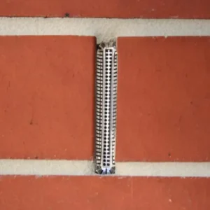 Weepa Protector Weep Ale Screen installed in a red brick wall.