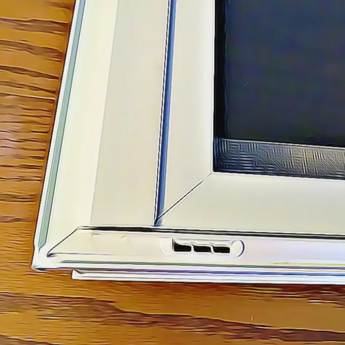 A window weep hole located at the bottom edge of the frame.